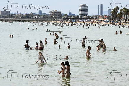 Beachgoers enjoy St Kilda beach