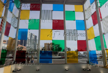 Tourists look at the Cube of the Centre Pompidou Modern Art Museum, in Malaga