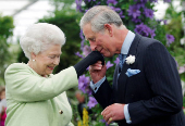 FILE PHOTO: Britain's Prince Charles kisses hand of Queen Elizabeth after she presented him with Royal Horticultural Society Victoria Medal of Honour in London