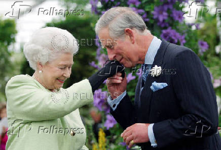 FILE PHOTO: Britain's Prince Charles kisses hand of Queen Elizabeth after she presented him with Royal Horticultural Society Victoria Medal of Honour in London