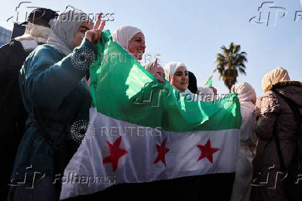 People gather after Syria's Bashar al-Assad was ousted, in central Damascus