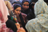 Palestinians receive aid following a ceasefire between Israel and Hamas, in Khan Younis in the southern Gaza Strip