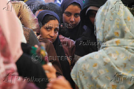 Palestinians receive aid following a ceasefire between Israel and Hamas, in Khan Younis in the southern Gaza Strip