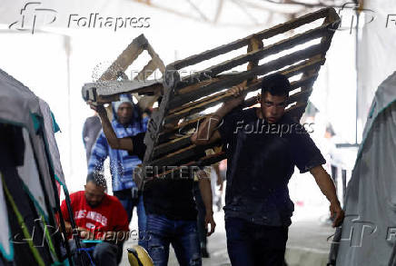 Asylum seekers wait in a temporary shelter for an opportunity to enter the U.S., in Matamoros