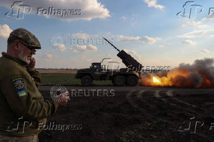 Ukrainian service members fire a Grad MLRS towards Russian troops near a front line in Donetsk region