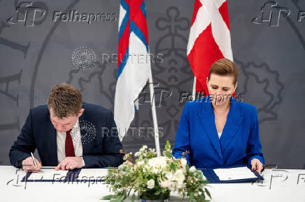 Denmark's Prime Minister Mette Frederiksen and the Faroese Prime Minister Aksel V. Johannesen sign a joint request to the Danish Supreme Court, in Prime Minister's Office, in Copenhagen