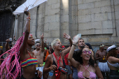 Revellers take part in the 'Chora Me Liga' block party during a pre-Carnival parade in Rio de Janeiro