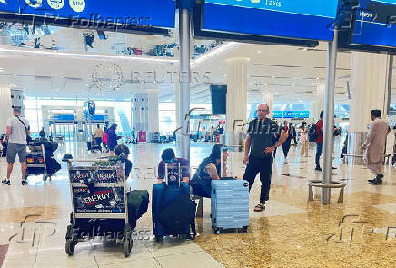 People wait for their flight at the Dubai International Airport