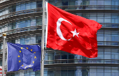 FILE PHOTO: European Union and Turkish flags fly outside a hotel in Istanbul