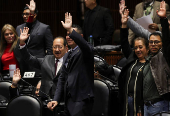 Congress members oppose a reform during a session, in Mexico City