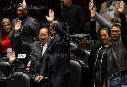 Congress members oppose a reform during a session, in Mexico City