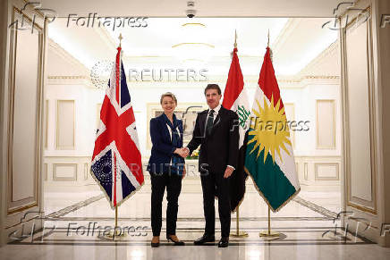 Britain's Home Secretary Yvette Cooper shakes hands with President of Kurdistan Region Nechirvan Barzani during a visit at the Kurdish Region Presidency, in Erbil