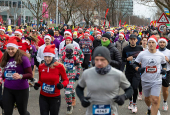 Runners wearing Santa Claus-themed outfits take part in the 