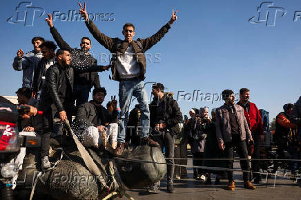 People gather in Umayyad Square after Syria's Bashar al-Assad was ousted in central Damascus