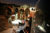 FILE PHOTO: Migrants are detained by U.S. Border Patrol agents in New Mexico