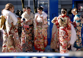 Kimono-clad young women stand at the venue for their Coming of Age Day celebration ceremony in Yokohama