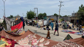 People take refuge along an expressway after relief camps reached maximum capacity in Maiduguri