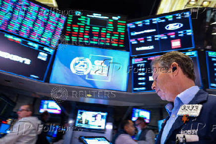 Traders work on the floor of the NYSE in New York