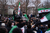 FILE PHOTO: People gather after Syrian rebels announced that they have ousted President Bashar al-Assad, in Vienna