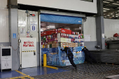 Workers handle boxes of flowers for export before Valentine?s Day, in Quito