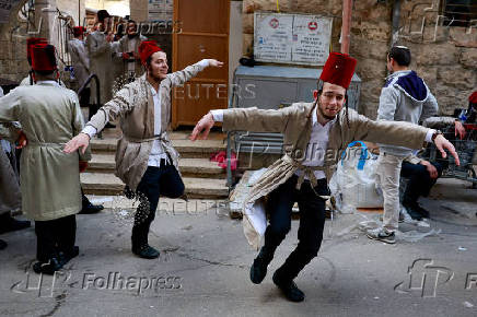FILE PHOTO: Ultra-Orthodox Jewish men mark the holiday of Purim, in Jerusalem