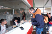 Tourists at the information center to register and receive a QR code to prove their payment of a fee for day trippers introduced by Venice