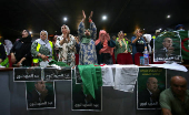 Supporters of Algeria's President and presidential candidate Abdelmadjid Tebboune gesture during a campaigning rally in Algiers