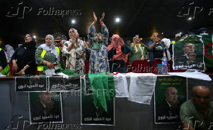 Supporters of Algeria's President and presidential candidate Abdelmadjid Tebboune gesture during a campaigning rally in Algiers