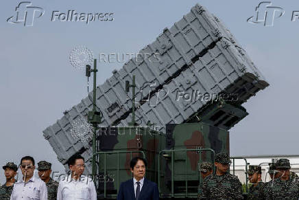 Taiwanese President Lai Ching-te is seen in front of the Hsiung Feng III mobile missile launcher during a visit to the base in response to recent Chinese military drills, in Taoyuan