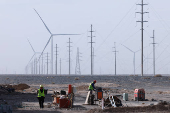 Workers work at a construction site at a Taiyuan New Energy Co wind farm, during an organised media tour, in Jiuquan