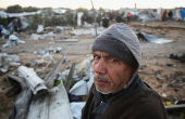 Palestinians inspect the damage at a tent camp sheltering displaced people, in Khan Younis