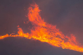 Firefighters and aircraft battle the Hughes Fire near Santa Clarita