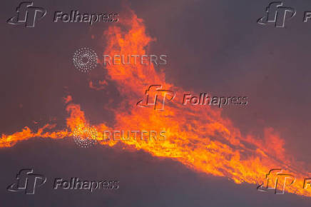 Firefighters and aircraft battle the Hughes Fire near Santa Clarita