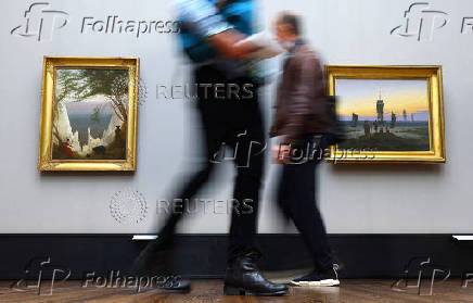 People watch the painting by German Romantic landscape painter Caspar David Friedrich in Berlin