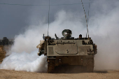 Israeli armoured personnel carrier (APC) manoeuvres near the Israel-Gaza border