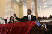 Venezuelan Vice-President Maduro holds a replica of Simon Bolivar's sword over the coffin of Venezuela's late President Chavez in Caracas