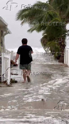 A man walks near the beach at Indian Shores