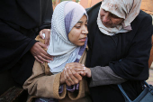 Palestinians mourn loved ones killed in Israeli strikes, in Khan Younis in the southern Gaza Strip