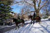 Members of the Parks Enforcement Patrol patrol on horseback in Central Park, in New York