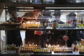 Ultra Orthodox Jews light Hanukkah holiday candles in Jerusalem