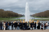 Members of the media attend the Apollo's Chariot fountain presentation after its renovation in the park of the Chateau de Versailles