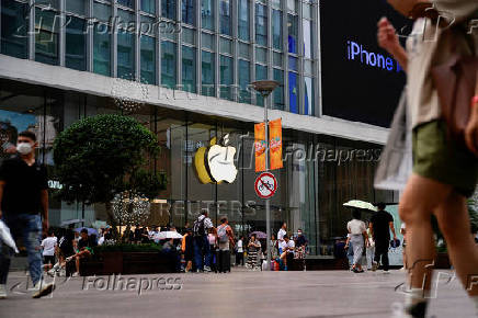 FILE PHOTO: People walk past an Apple store in Shanghai