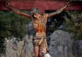 FILE PHOTO: A woman touches a crucifix at the site where the Virgin Mary reportedly appeared in an apparition in Medjugorje