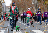 Runners wearing Santa Claus-themed outfits take part in the 