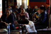 Tibetans in Nepal offer prayers at a monastery in memory of those killed in the recent earthquake, at the Tibetan Refugee Camp in Lalitpur