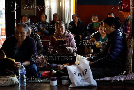 Tibetans in Nepal offer prayers at a monastery in memory of those killed in the recent earthquake, at the Tibetan Refugee Camp in Lalitpur