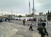 Palestinians go through checkpoint on way to al-Aqsa for Friday prayers during Ramadan, in Bethlehem