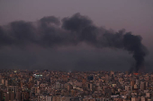 Smoke billows over Beirut's southern suburbs, as seen from Sin El Fil