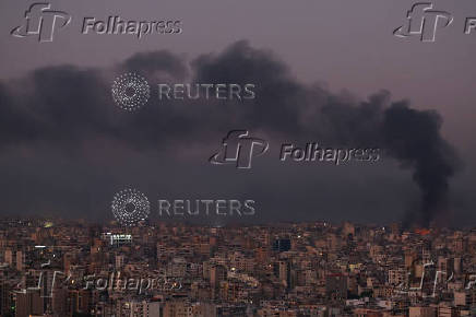 Smoke billows over Beirut's southern suburbs, as seen from Sin El Fil