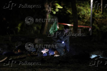 Israeli emergency services work at the scene of a missile strike, in Jaffa, south of Tel Aviv